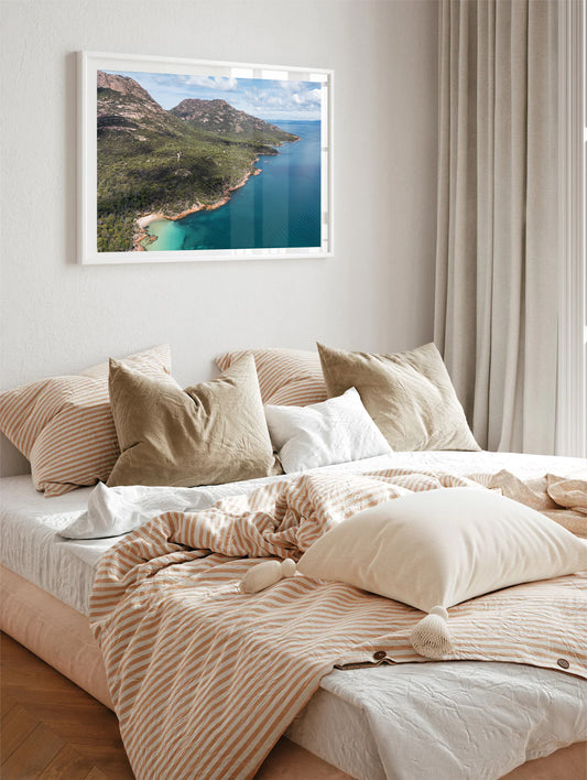 Scenic drone view of Freycinet National Park’s mountain range meeting green-blue ocean