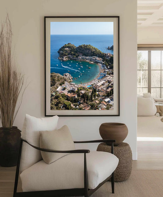 Drone image looking out to sea over golden sand and turquoise boats at Spiaggia di Mazzarò, captured in rich Italian summer light.