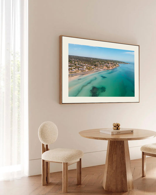 Olivers Hill Frankston aerial print in a natural oak frame styled above a dining table
