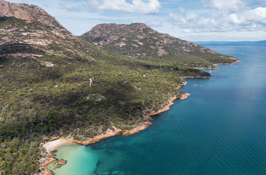 Aerial photo of Freycinet Mountains and turquoise coastline in southern Tasmania