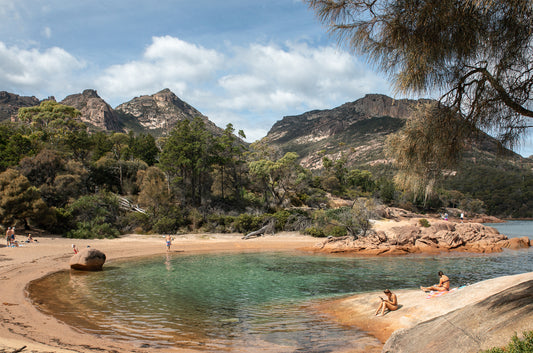 Orange coastal rocks and green water at Honeymoon Bay, Tasmania 
