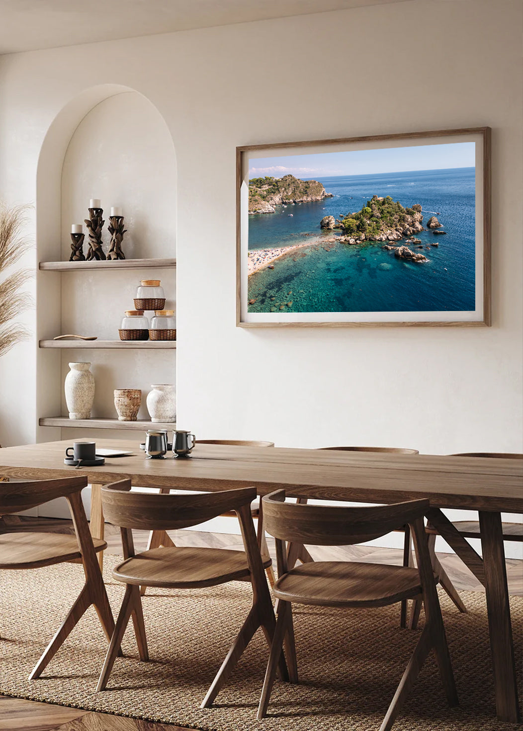 Drone photograph of rocky Isola Bella Island in Sicily, showing clear water and coastal textures from a high vantage point.