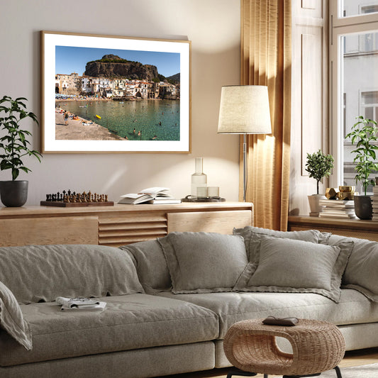 Wide wall art photograph from Cefalù, Sicily showing the old town buildings along the shoreline, viewed from the jetty.