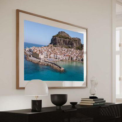 Cefalù Old Town from the Sea wide aerial coastal photography print taken offshore in Sicily, showing the historic town and blue Mediterranean waters.