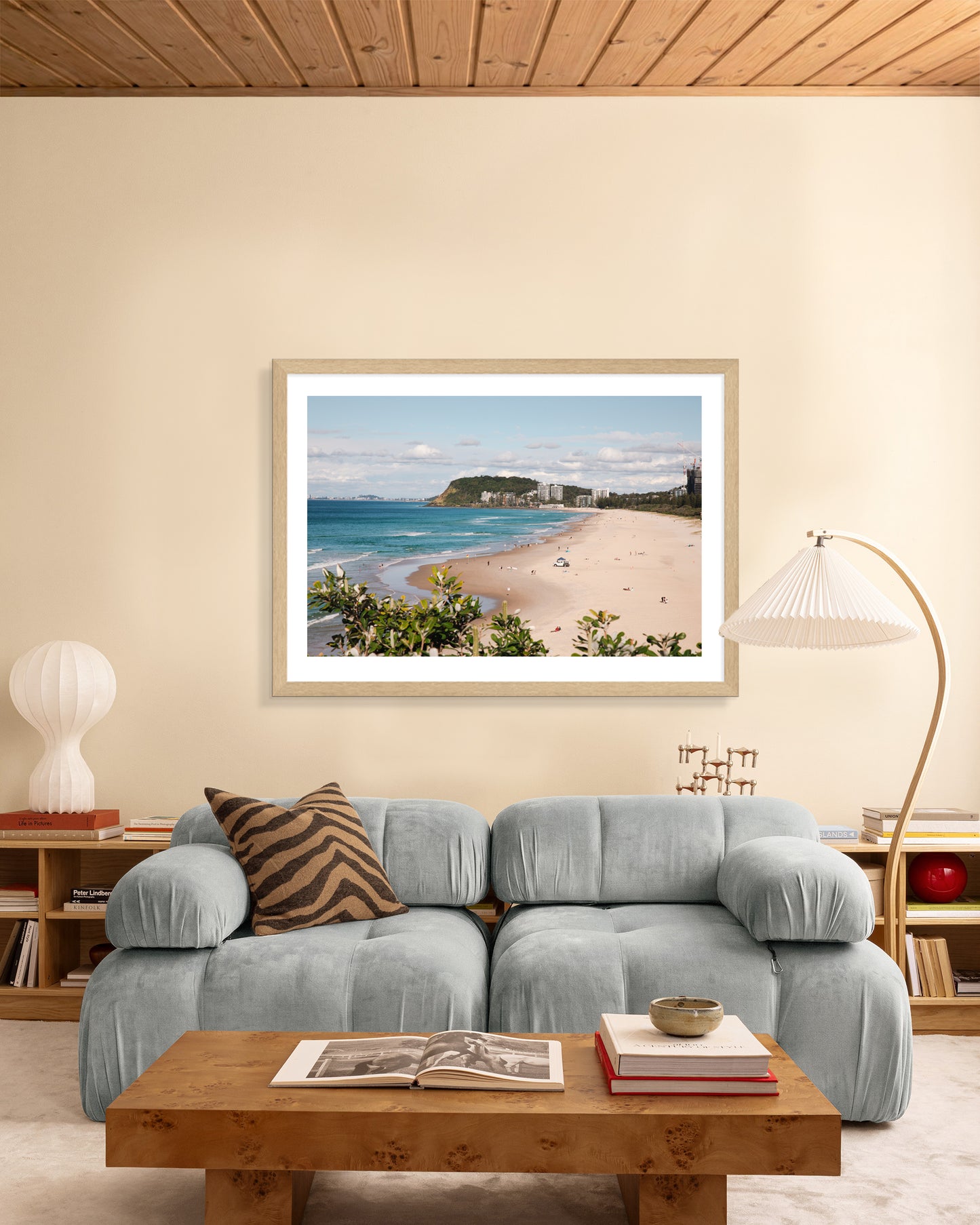 North Burleigh beach print in a natural oak frame styled in a living room