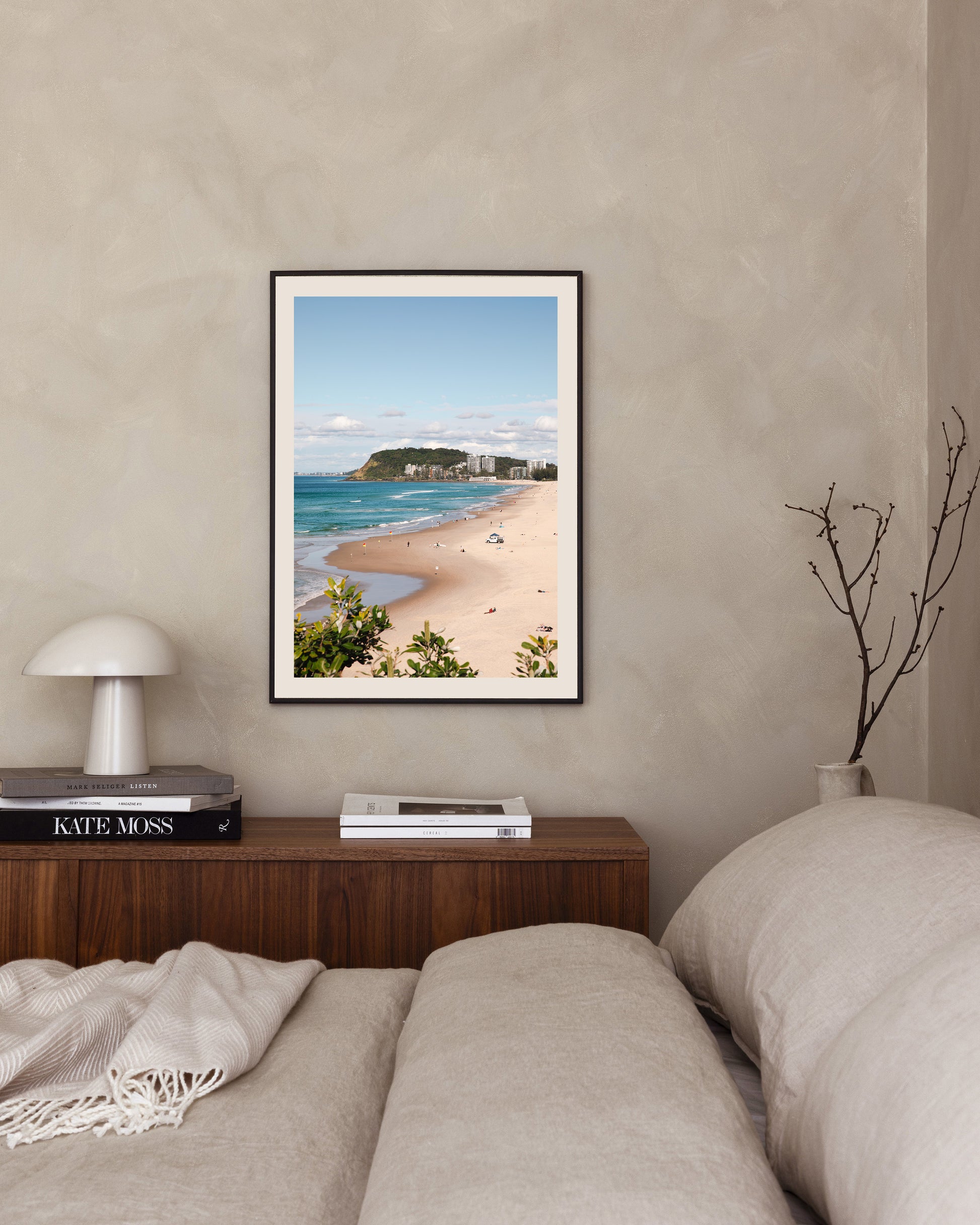 North Burleigh beach print in a black frame styled in a bedroom