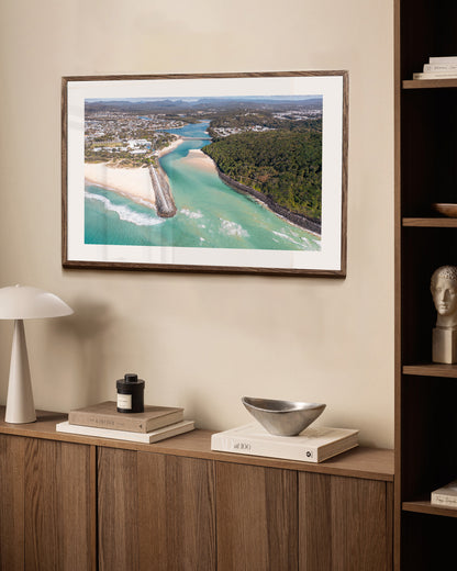 Tallebudgera Creek aerial print in a dark walnut frame styled above a sideboard