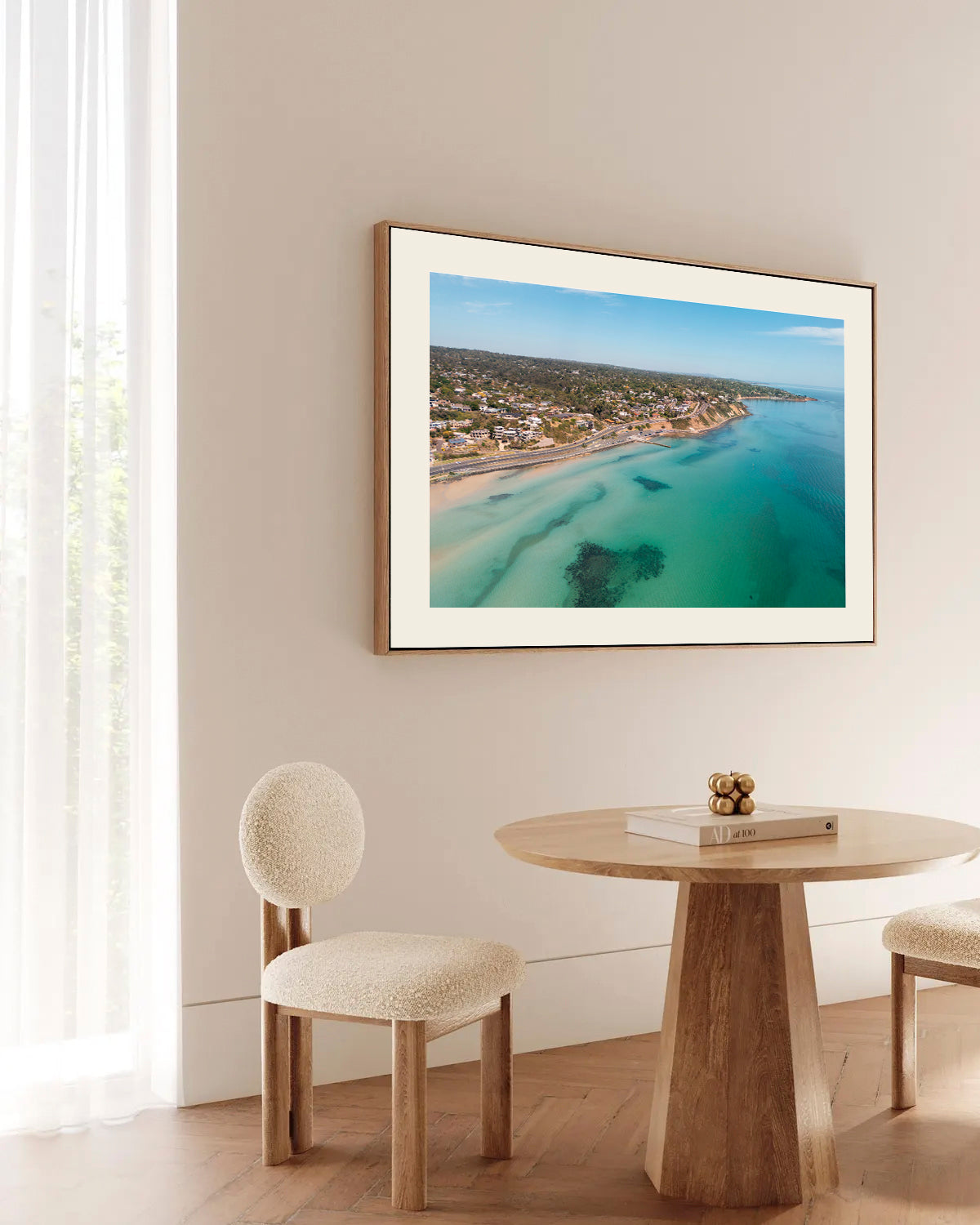 Olivers Hill Frankston aerial print in a natural oak frame styled above a dining table