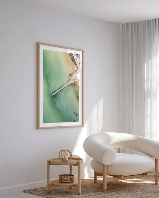 Olivers Hill pier aerial print in a natural oak frame styled in a living room