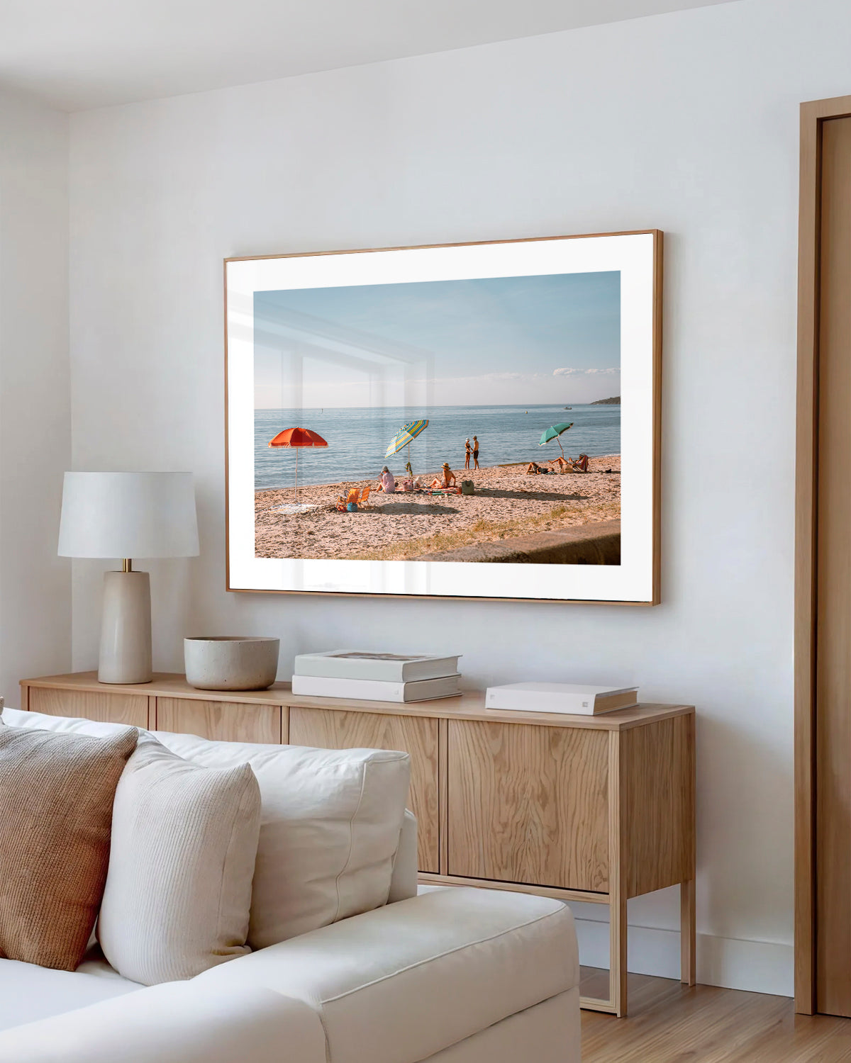 Dromana Beach Mornings print in a natural oak frame styled in a living room