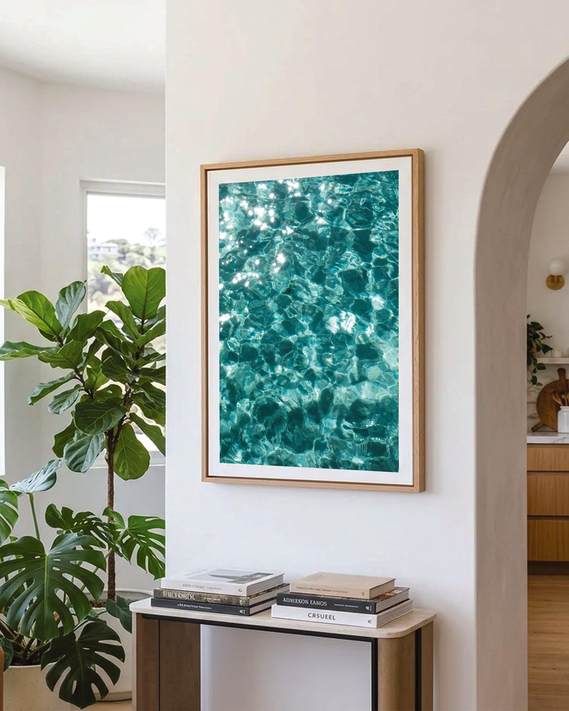 Crystal clear waters abstract print in a natural oak frame styled in a hallway