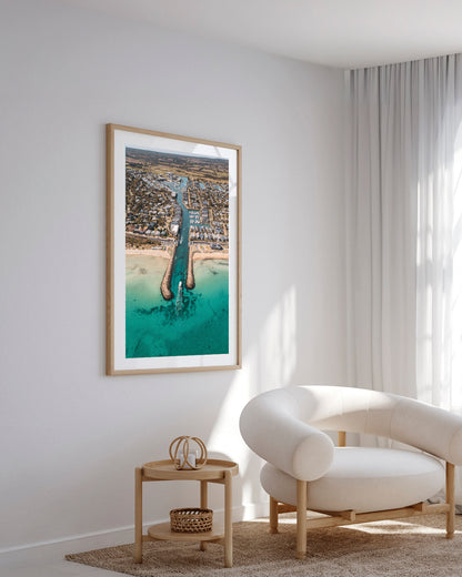 Safety Beach aerial inlet print in a natural oak frame styled in a living room