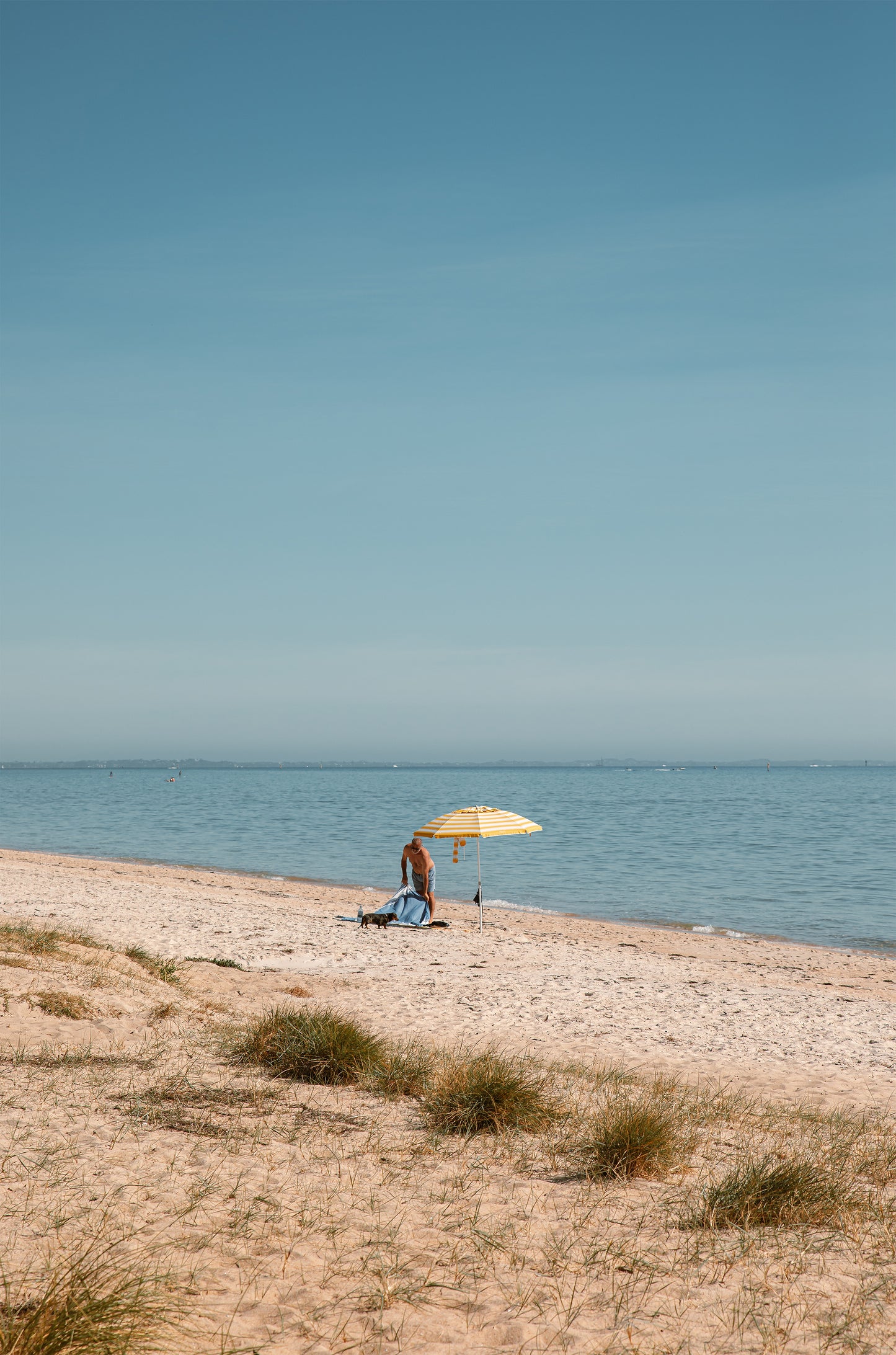 Solo morning under a striped umbrella on Dromana Beach, Mornington Peninsula – coastal wall art print