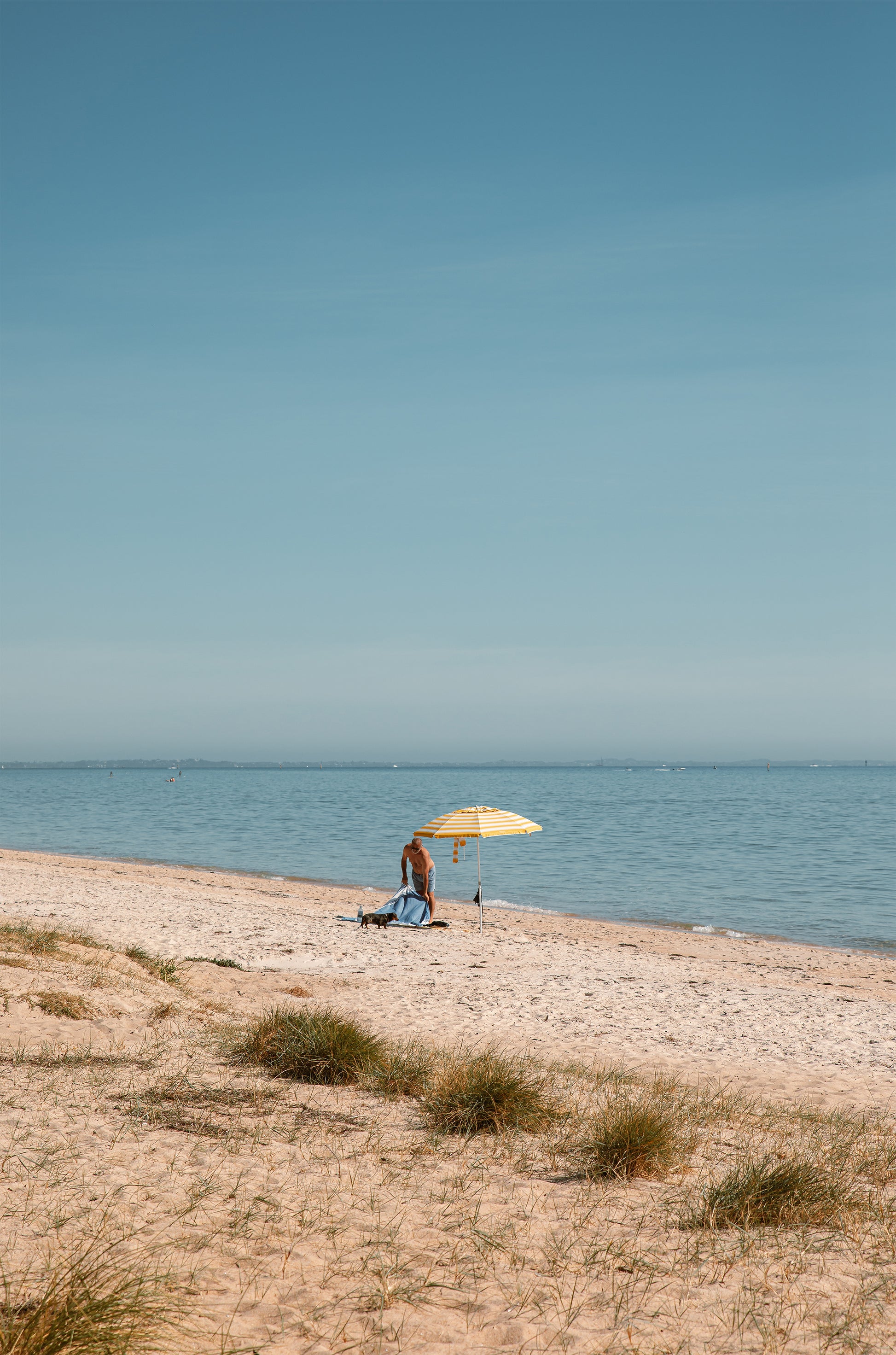 Solo morning under a striped umbrella on Dromana Beach, Mornington Peninsula – coastal wall art print