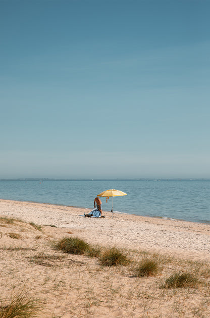 Solo morning under a striped umbrella on Dromana Beach, Mornington Peninsula – coastal wall art print