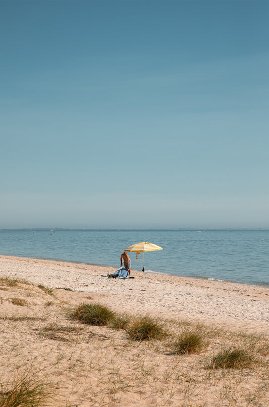 Solo morning under a striped umbrella on Dromana Beach, Mornington Peninsula – coastal wall art print