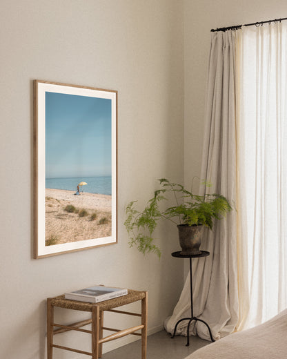 Dromana Beach coastal print in a natural oak frame styled in a calm bedroom