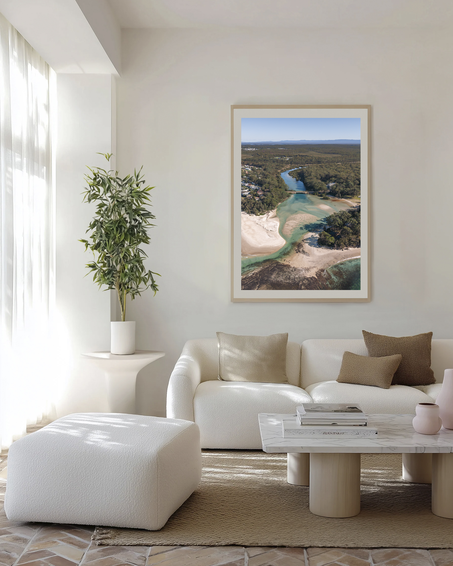 Moona Moona Creek print in a natural oak frame, styled above a cream boucle lounge with a marble coffee table.