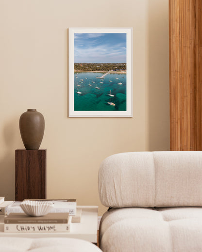 Sorrento Sailing Club portrait print in a white frame, styled beside a timber feature wall and dark ceramic vase.